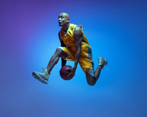 flight-handsome-african-american-male-basketball-player-motion-action-neon-light-blue-wall